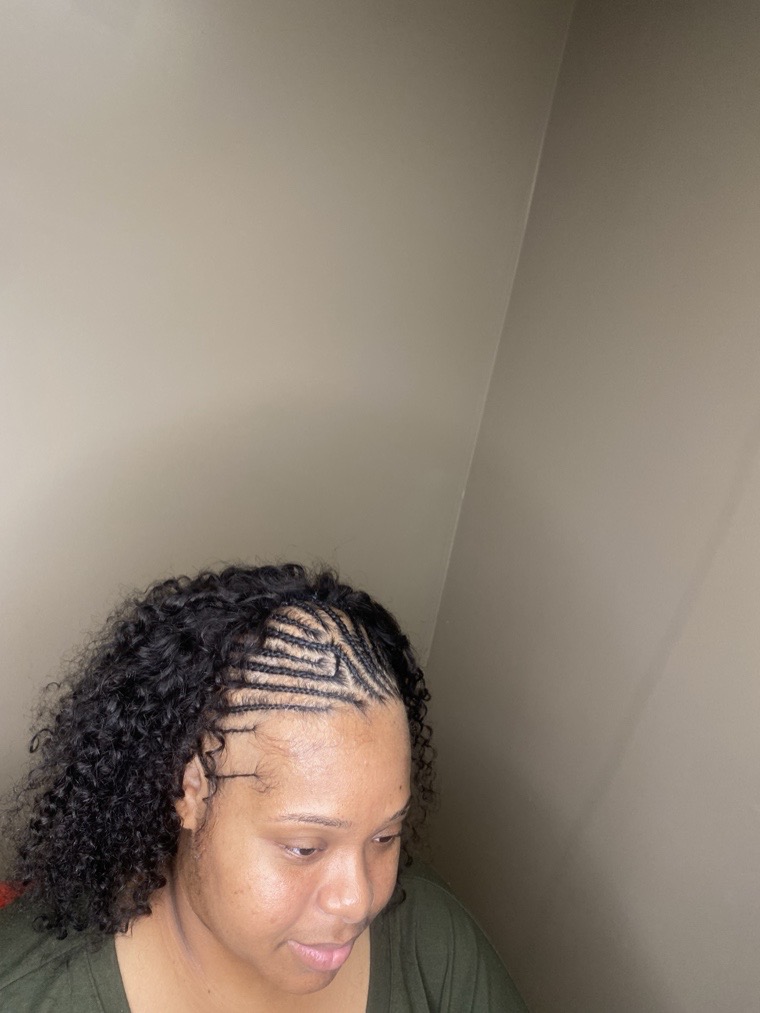Feed-in cornrows with natural curls left loose at the front.