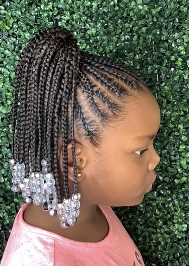 Child's braided ponytail finished with beads.