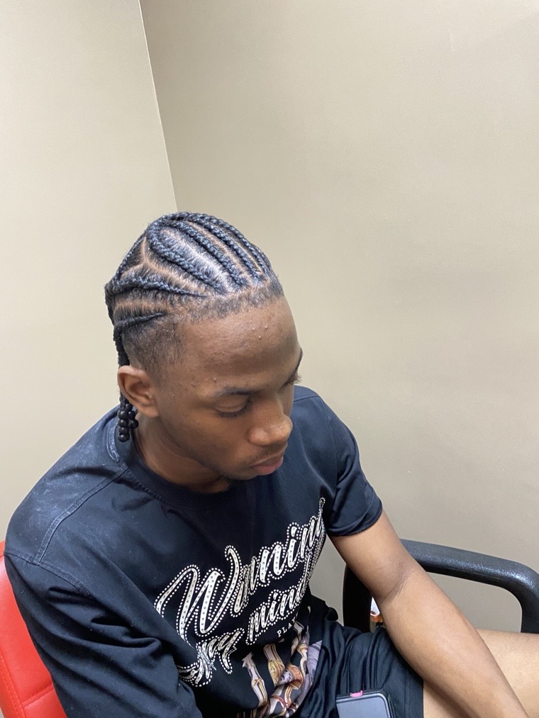 Men's straight-back cornrows, neatly parted.